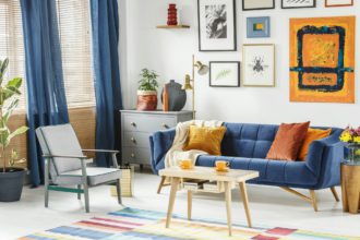 Bright and cozy living room interior with blue drapes, a sofa wi