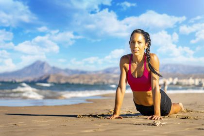 Young woman practicing yoga outdoors. Harmony, self care, mindfulness and meditation concept.